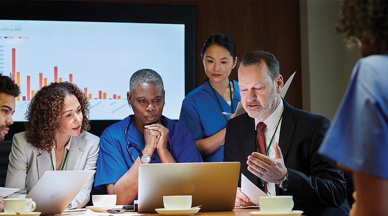 healthcare leaders meet around table