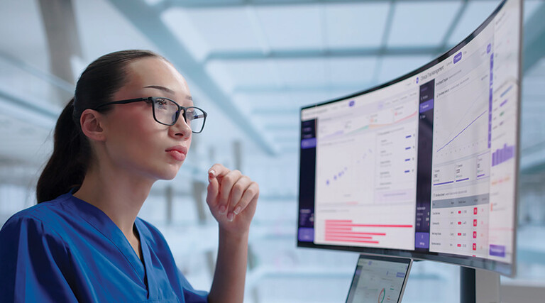 clinician looks at data on a monitor