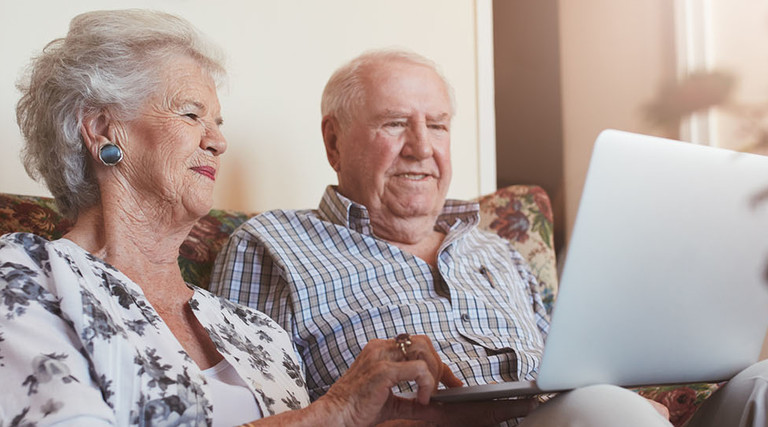 elderly couple using technology