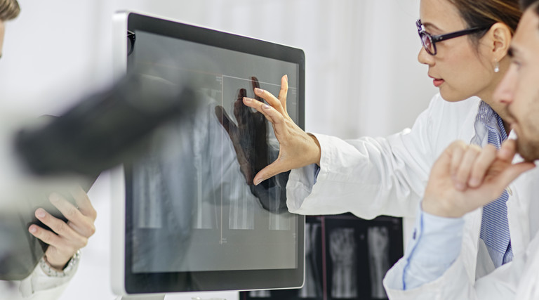 doctors looking at images on a screen