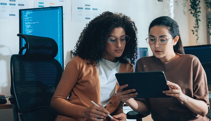 two IT leaders read document on tablet