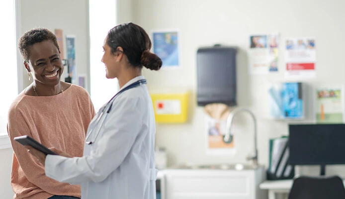 doctor and patient smiling at appointment