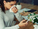 Girl sick with flu on her smartphone