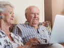 elderly couple using technology