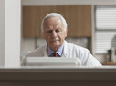 man at computer in doctor's office