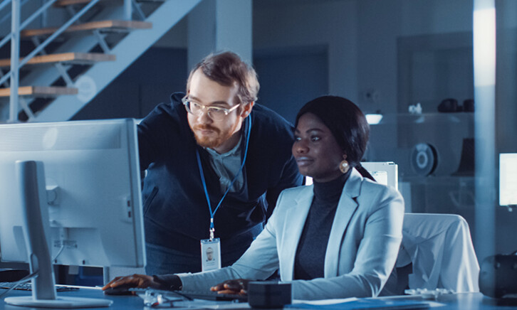 IT team confers over monitor