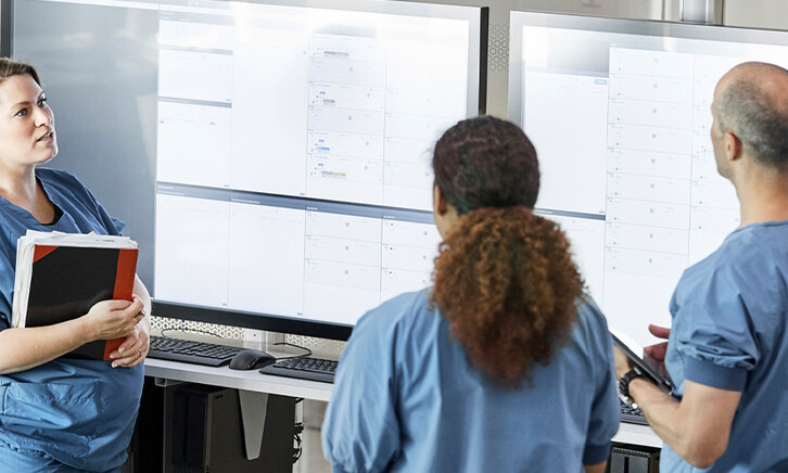 Doctors reviewing information boards