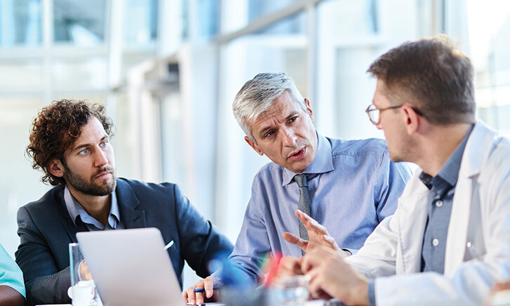healthcare team have discussion around table
