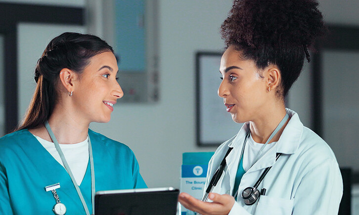 nurse and doctor collaborate over tablet