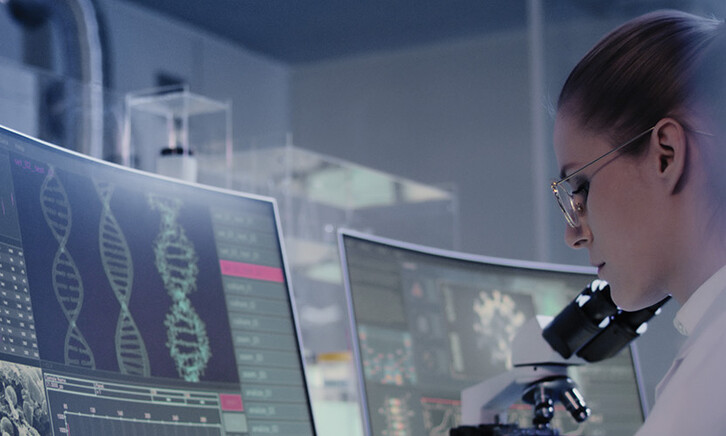 scientist looks at DNA on a computer