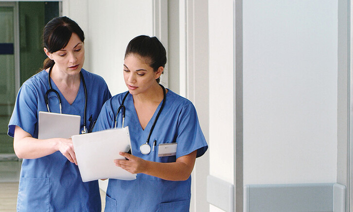nurses with paper charts