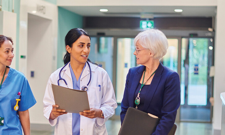 Hospital workers walking down a hallway