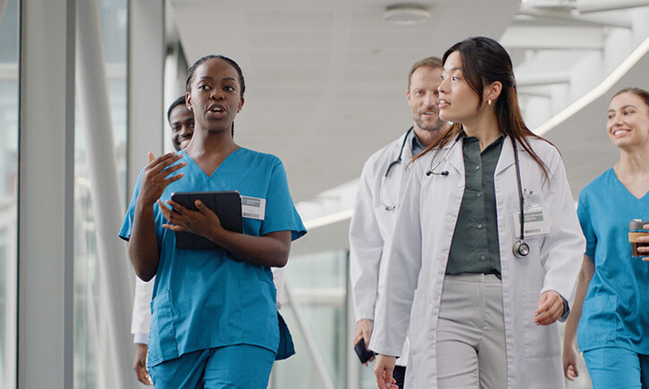 clinicians walking in hospital hallway