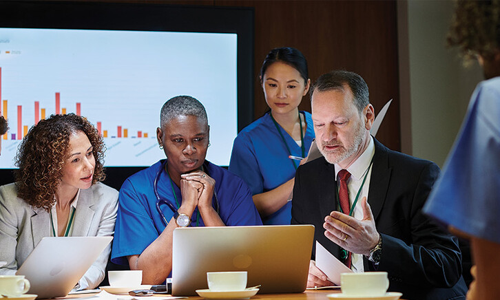 healthcare leaders meet around table