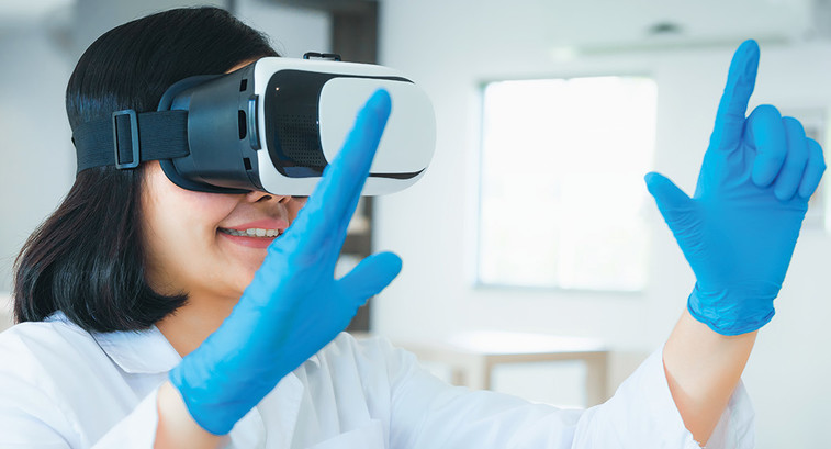 resident in white coat trains using virtual reality glasses