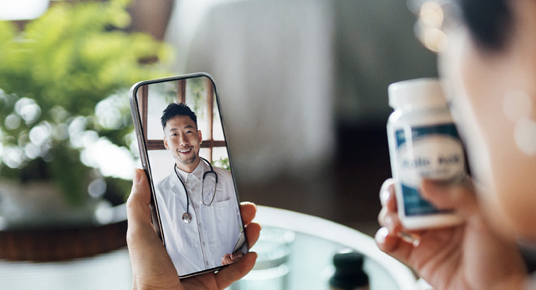 Elderly person speaking to doctor via telehealth