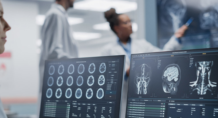 Medical Scientist Using Computer with MRI Images