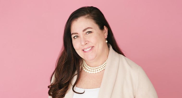 Dr. Sarah Pletcher against pink background