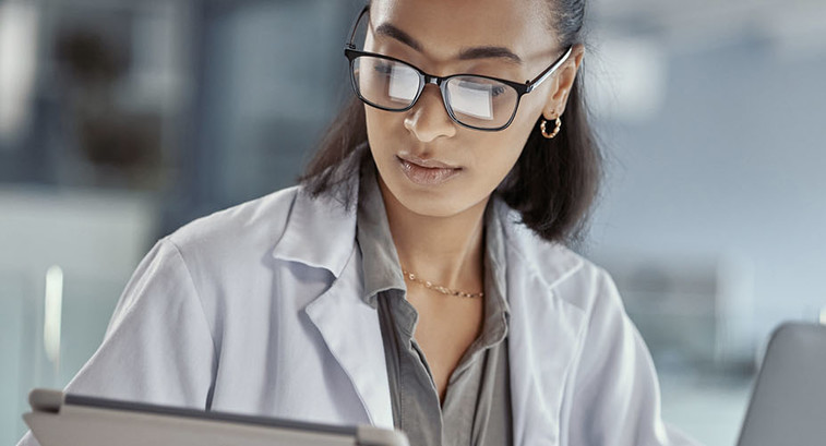 Doctor using tablet and laptop