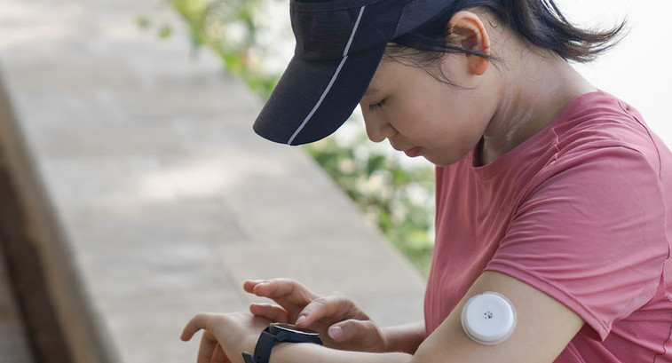 Person wearing glucose monitor 