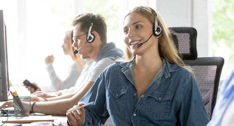 Woman uses headset in call center