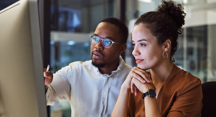 IT team members look at platform on desktop