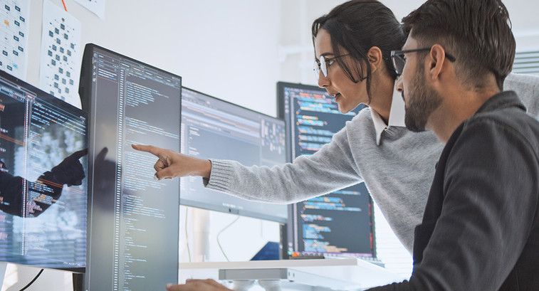 cyber team looks at code on several monitors