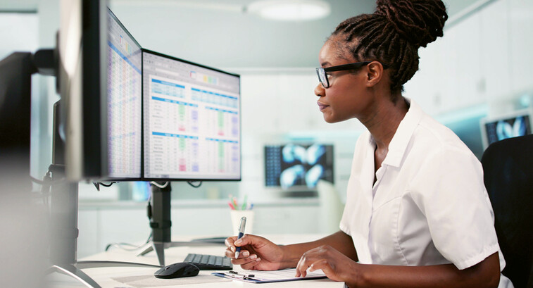 Women at desk working on computer