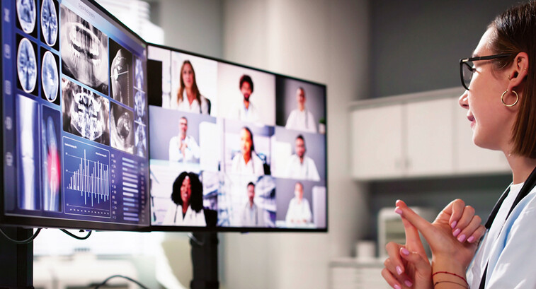 doctor on video call with several care team members