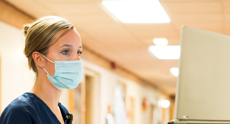 Doctor using medical laptop in hospital