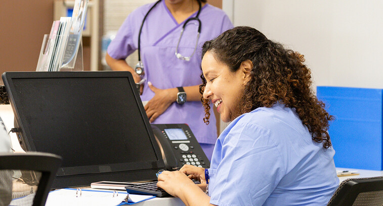 Nurse working at the front desk of a hospital