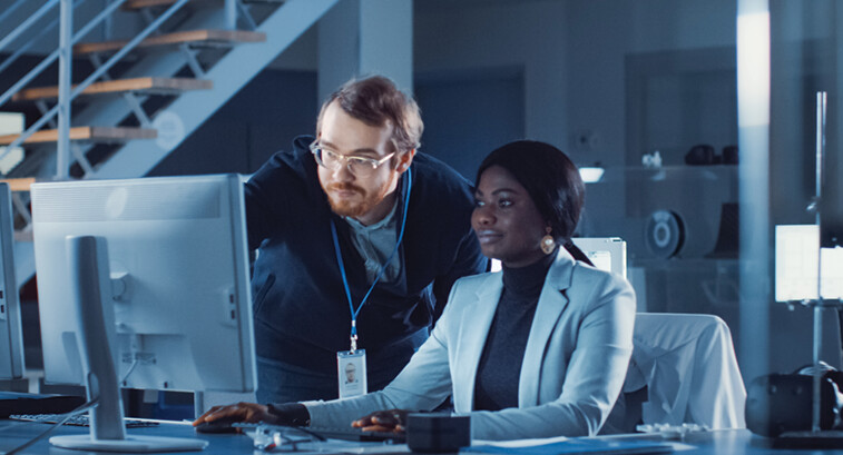 IT team confers over monitor