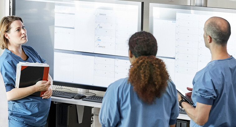 Doctors reviewing information boards