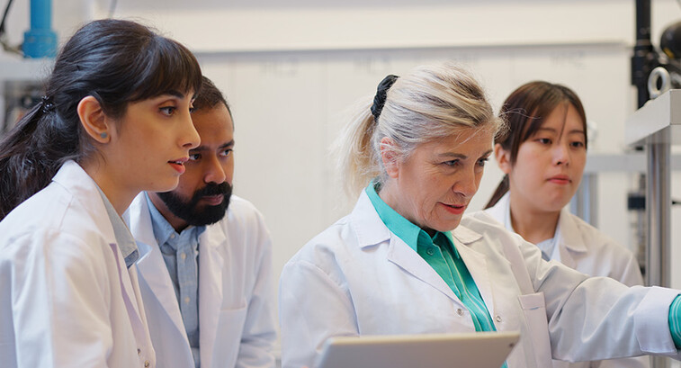 doctors gathered around computer