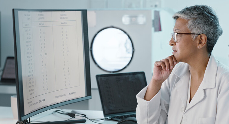 doctor's look at computer monitor together