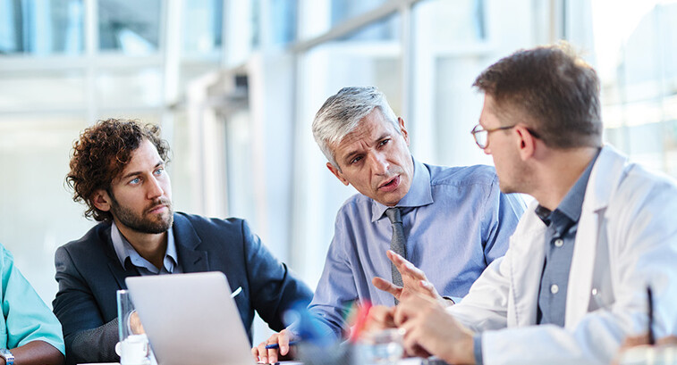 healthcare team have discussion around table