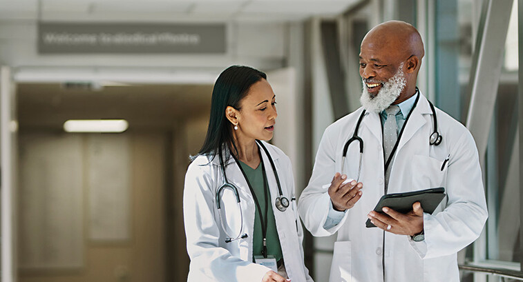 two doctors smile as they walk