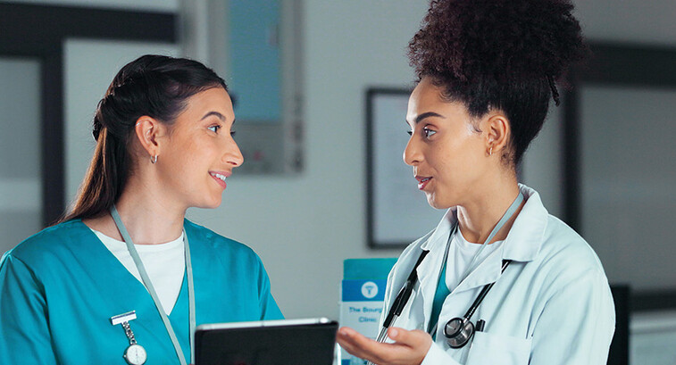 nurse and doctor collaborate over tablet
