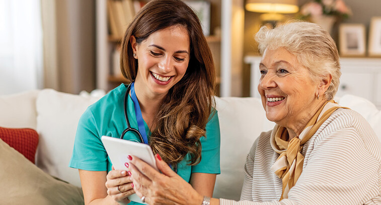 nurse and senior look at technology