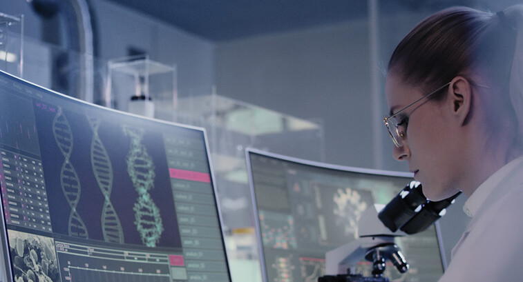 scientist looks at DNA on a computer