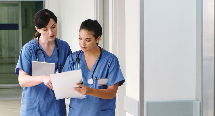 nurses with paper charts