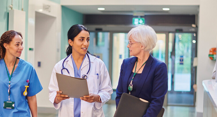 Hospital workers walking down a hallway