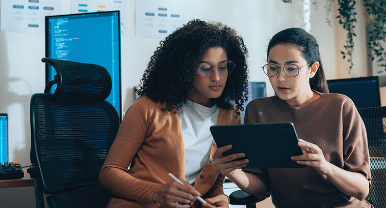 two IT leaders read document on tablet
