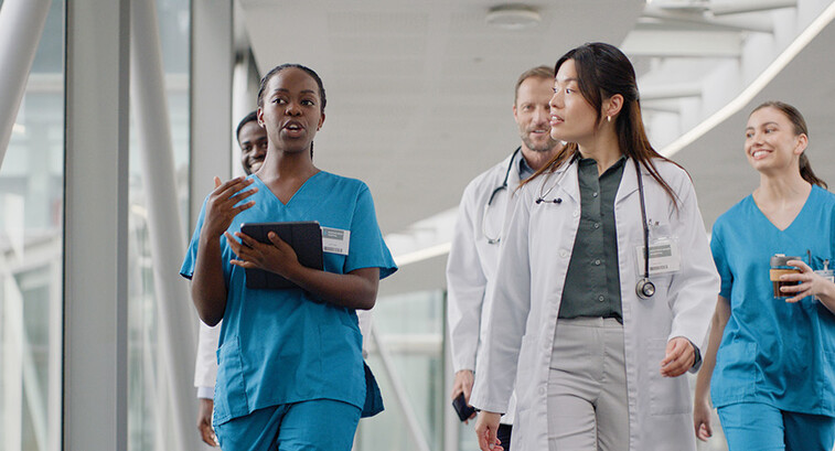 clinicians walking in hospital hallway