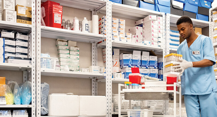 man grabs supplies in pharmacy supply room
