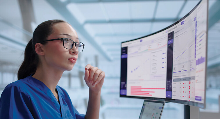 clinician looks at data on a monitor