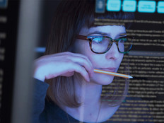 woman analyzes data on computer screen