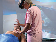 Nurse uses virtual reality during patient exam