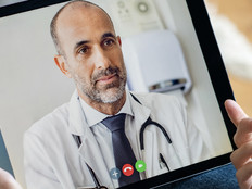 Doctor consulting with patient via telehealth
