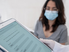 Doctor using tablet containing patient data